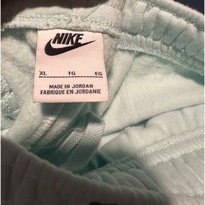 2 pairs Nike sweatpants -one lite mint green- one pink- one is L -1 XL